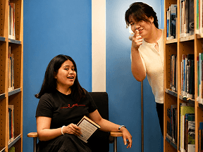 Two OmaApply team members sharing a laugh in the office