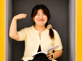 OmaApply team member laughing while reading
